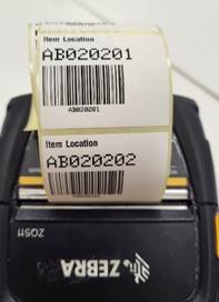A barcode label on a printer
Description automatically generated